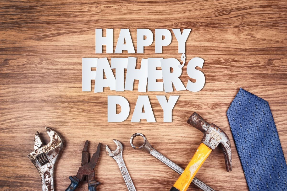 Paper cut of Happy Father's Day text with old rusty tools and ties on wooden background 